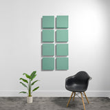 Eight mint green square acoustic panels arranged in a 2x4 grid on a white wall.
