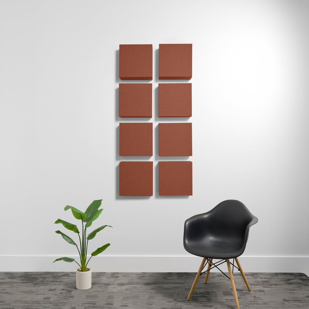 Eight terracotta-colored square acoustic panels arranged in a 2x4 grid on a white wall.