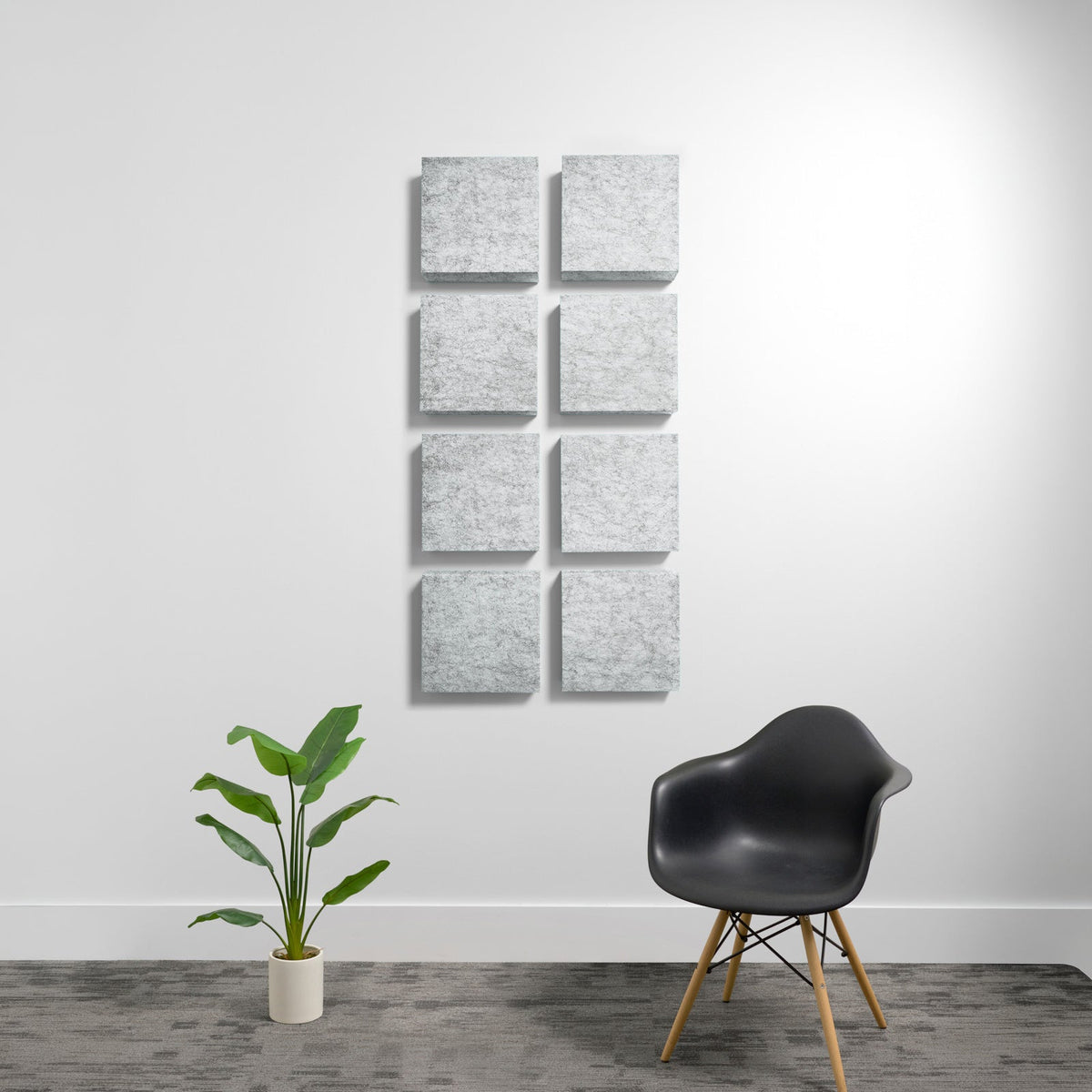 Eight gray textured acoustic panels arranged in two columns on a white wall.