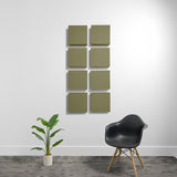 Eight olive-green square acoustic panels arranged in a 2x4 grid on a white wall.