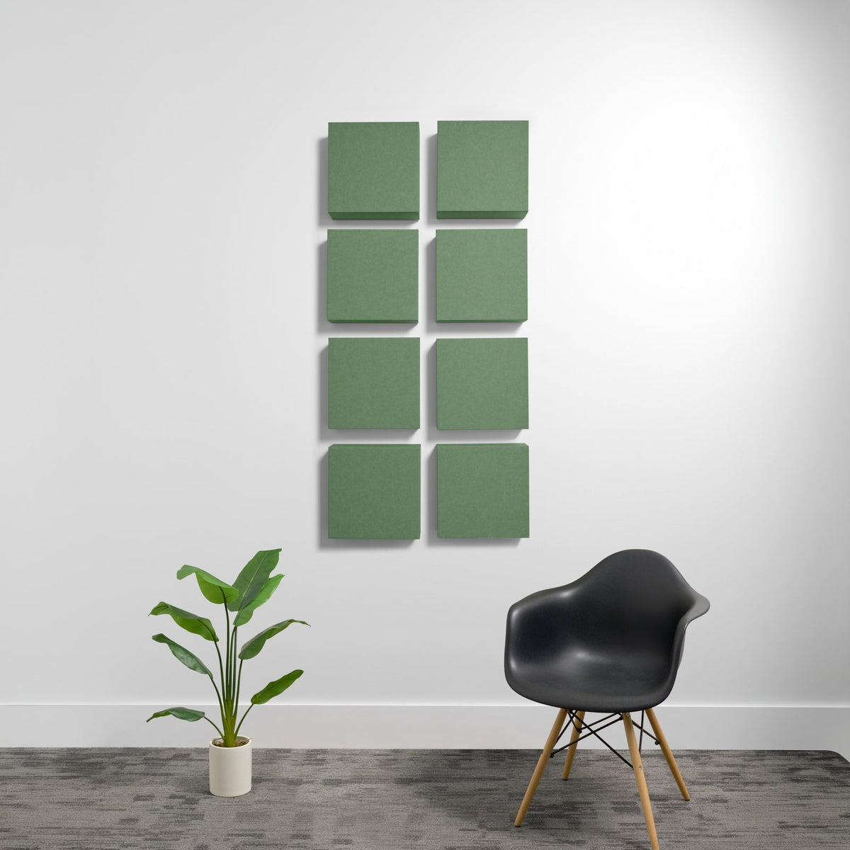 Eight green square acoustic panels mounted on wall in 2x4 grid arrangement.