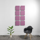Eight pink square acoustic panels mounted on wall in 2x4 grid arrangement.