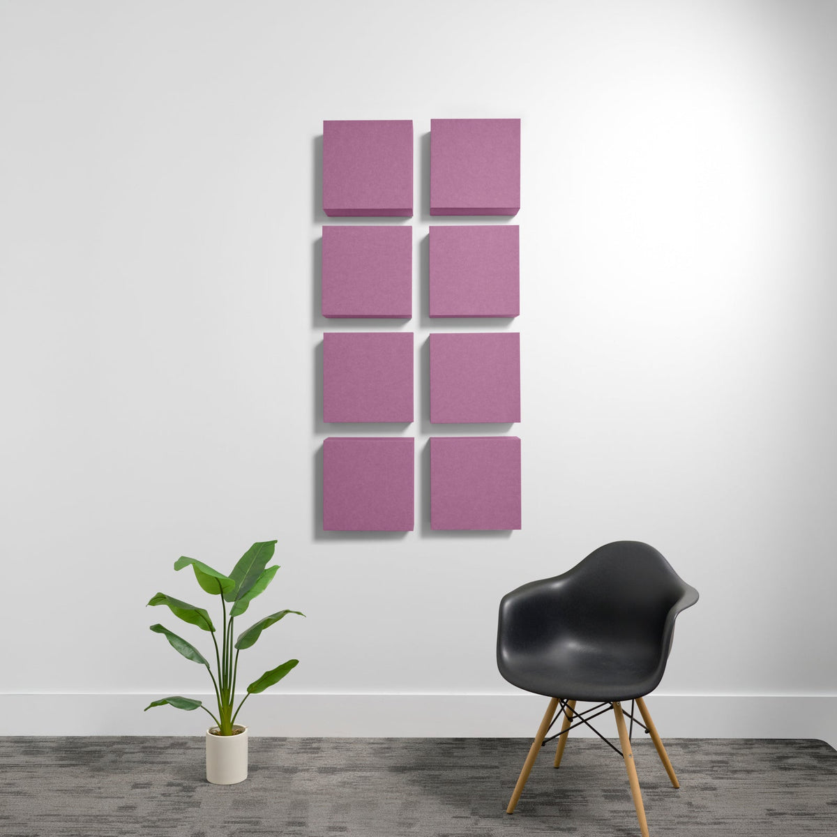 Eight pink square acoustic panels mounted on wall in 2x4 grid arrangement.