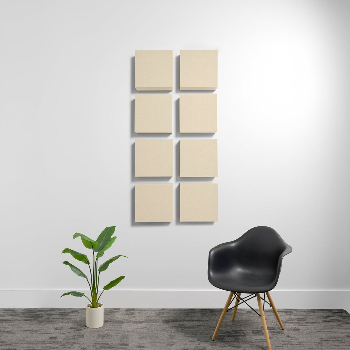 Eight beige square acoustic panels arranged in a 2x4 grid on a white wall.