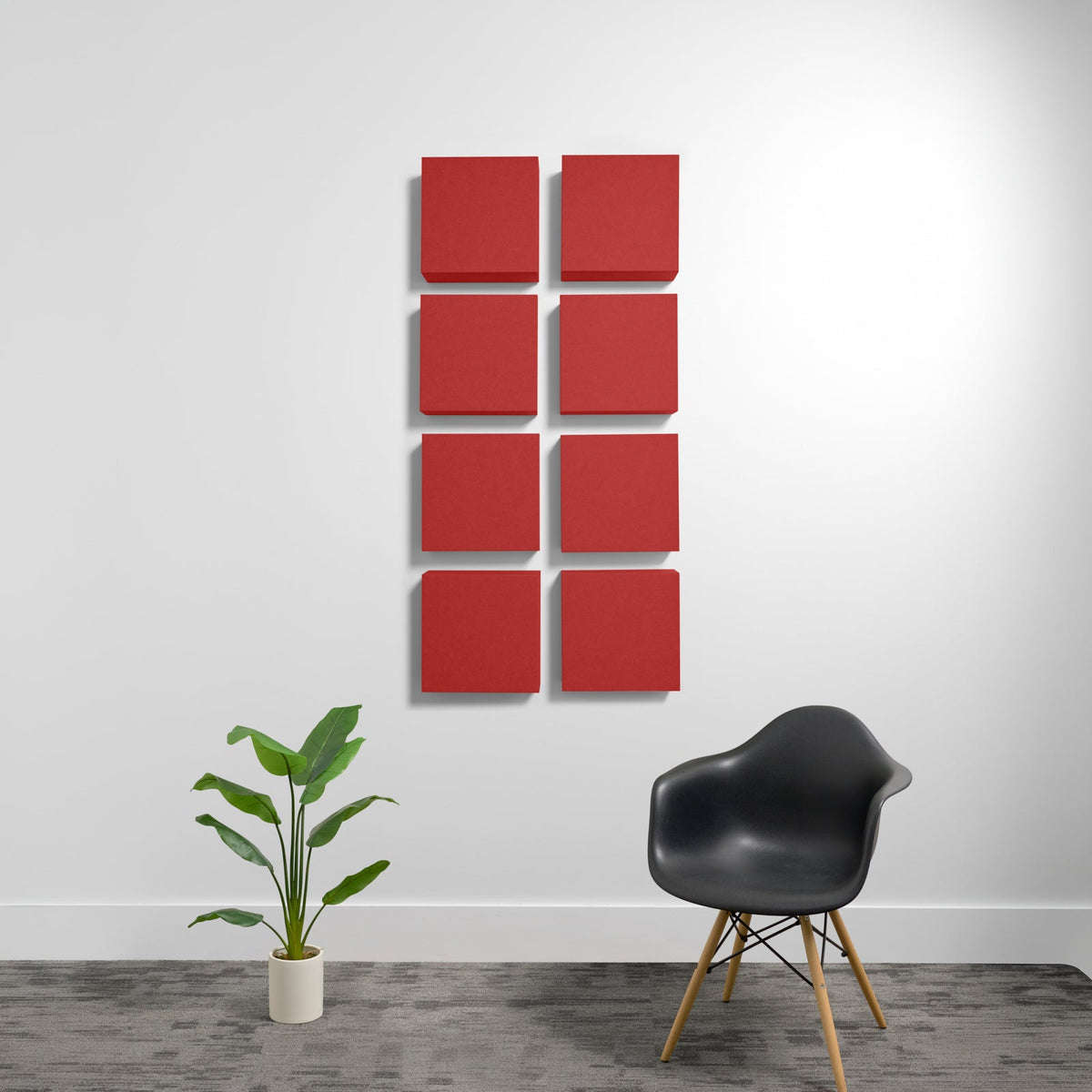 Eight red square acoustic panels mounted on white wall in two-column grid arrangement.