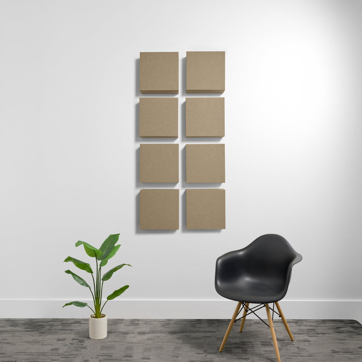 Eight tan square acoustic panels mounted on white wall in two columns.
