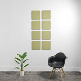 Eight olive-green square acoustic panels with 3D textured surfaces arranged in a 2x4 grid on a white wall.