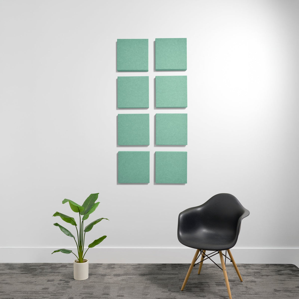 Eight sage green square acoustic panels with rounded corners arranged in a 2x4 grid on white wall.