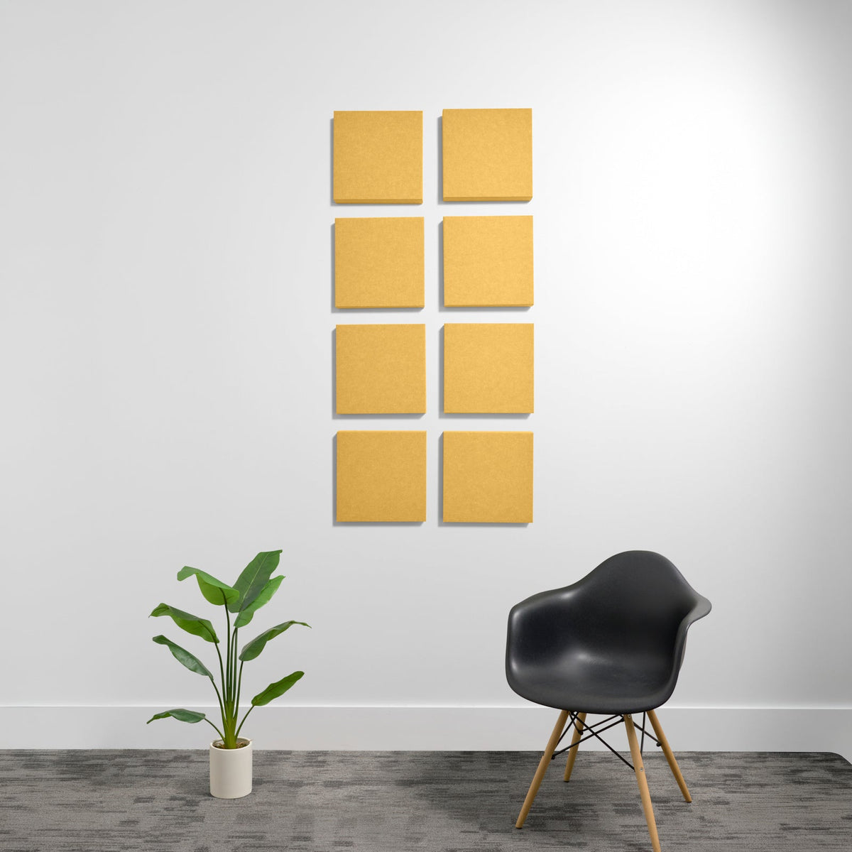 Eight golden-yellow square acoustic panels with beveled edges arranged in a 2x4 grid on white wall.