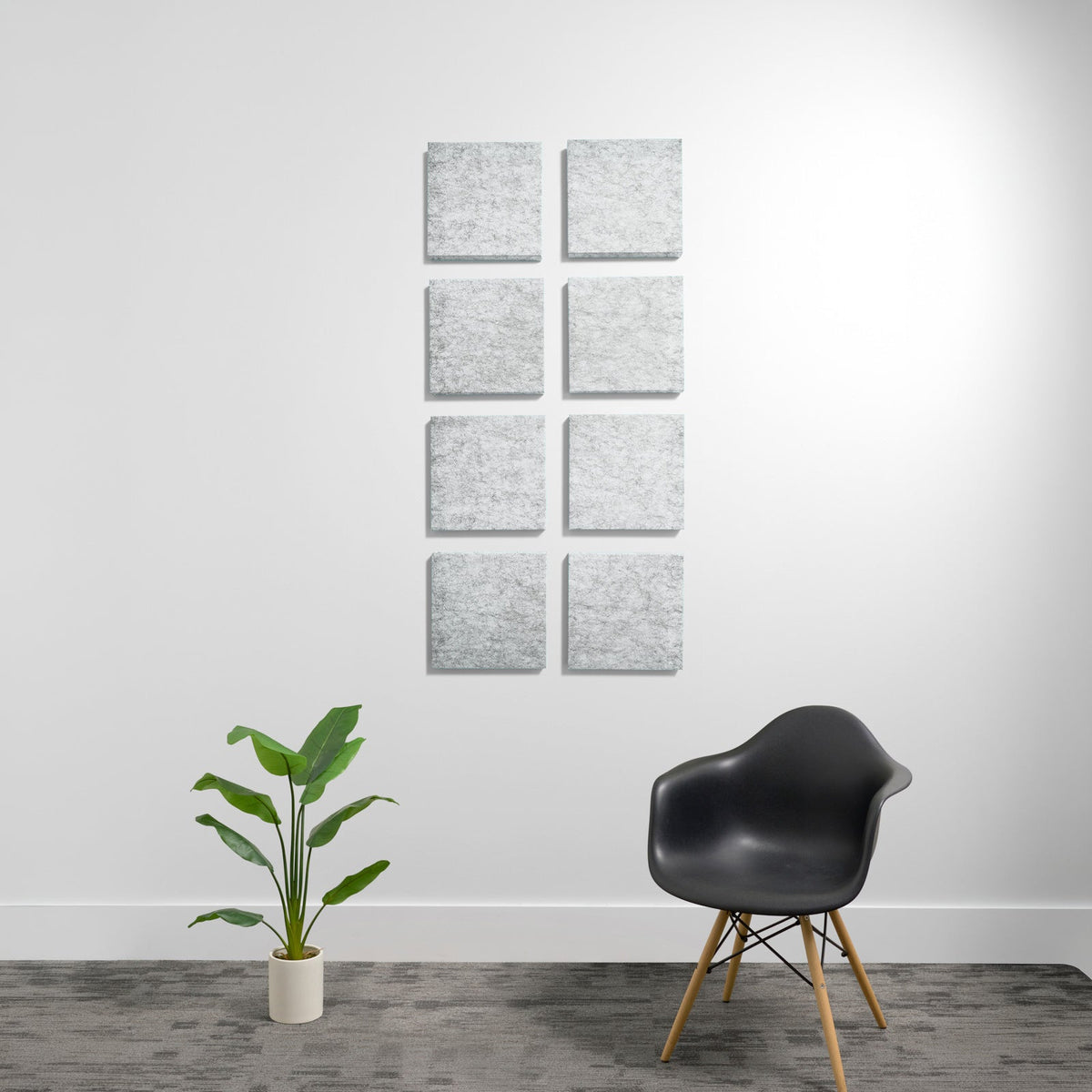 Eight light gray square acoustic panels mounted on white wall in two columns.