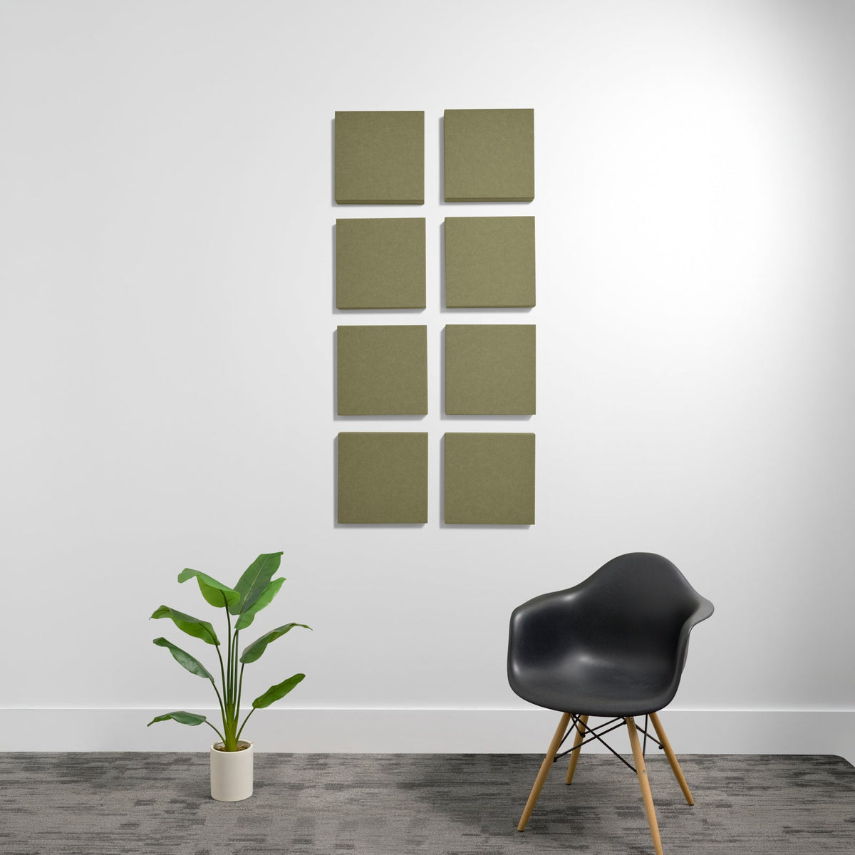 Eight olive-green square acoustic panels arranged in a 2x4 grid on a white wall.