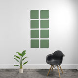 Eight sage green 3D acoustic panels arranged in a 2x4 grid on a white wall.
