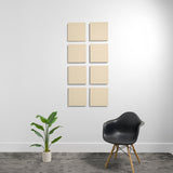 Eight beige square acoustic panels with beveled edges arranged in a 2x4 grid on a white wall.