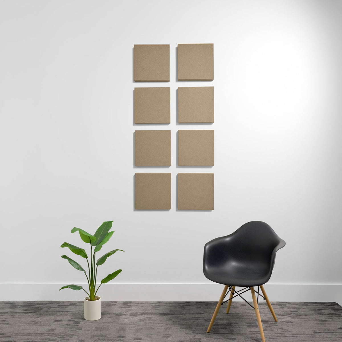 Eight tan square acoustic panels arranged in a 2x4 grid on a white wall.