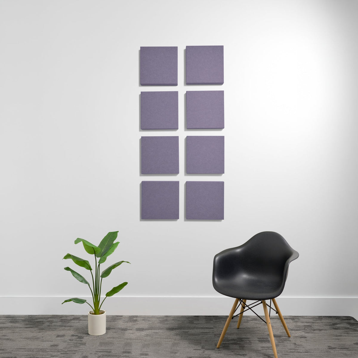 Eight purple square acoustic panels arranged in a 2x4 grid on a white wall.