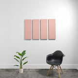 Four pink rectangular acoustic panels mounted on white wall above black chair and potted plant.