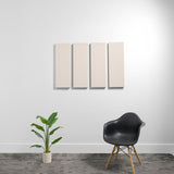 Four rectangular beige acoustic panels mounted on white wall above black chair and potted plant.