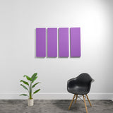 Four purple rectangular acoustic panels mounted on a white wall above a black chair and potted plant.