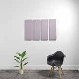 Four rectangular lavender acoustic panels mounted on a white wall above a black chair and potted plant.
