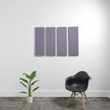 Four purple rectangular 3D acoustic panels mounted on white wall above a black chair and potted plant.