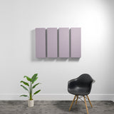 Four rectangular mauve acoustic panels mounted on white wall above black chair and potted plant.