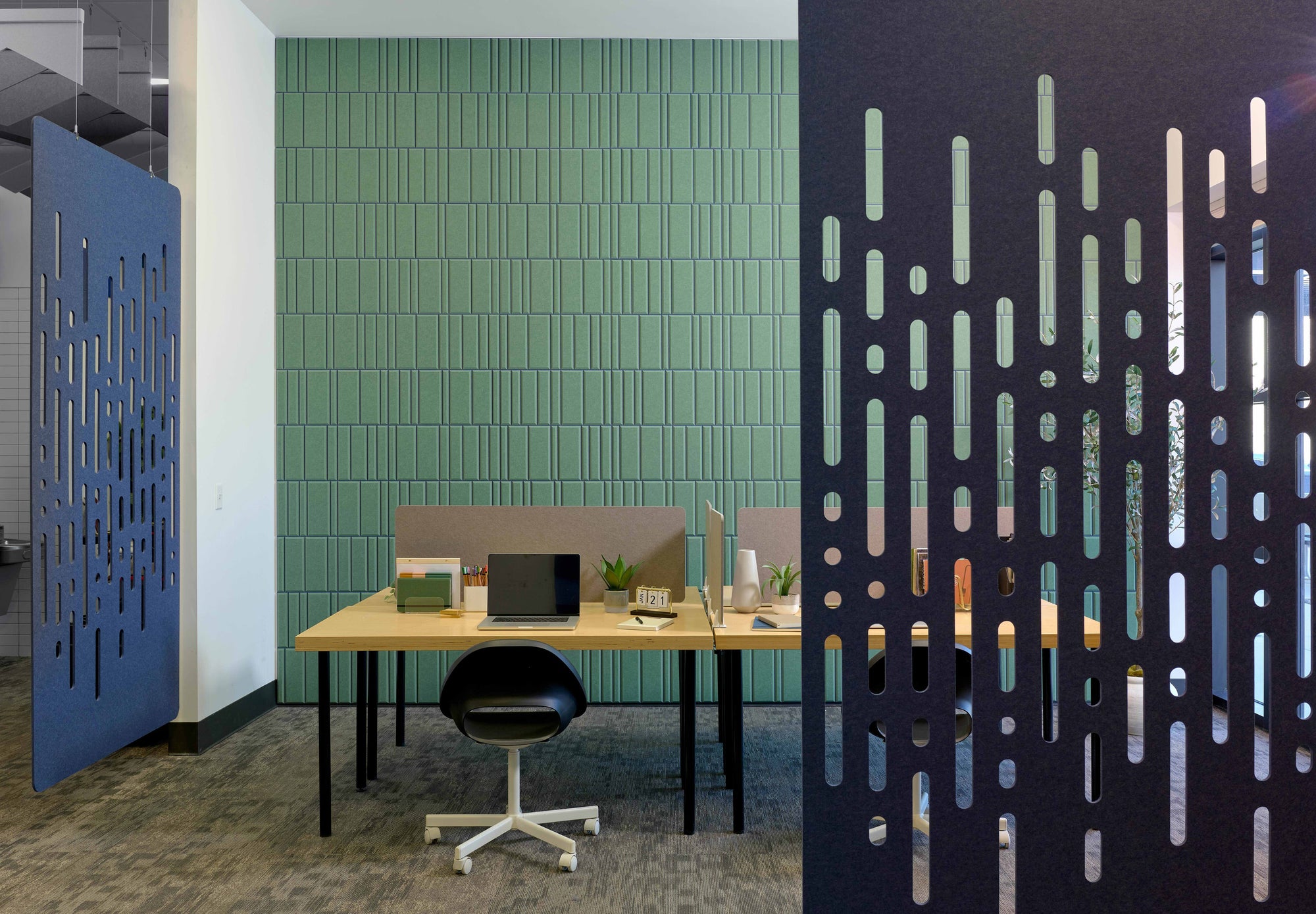 Two blue room dividers in a shared office space