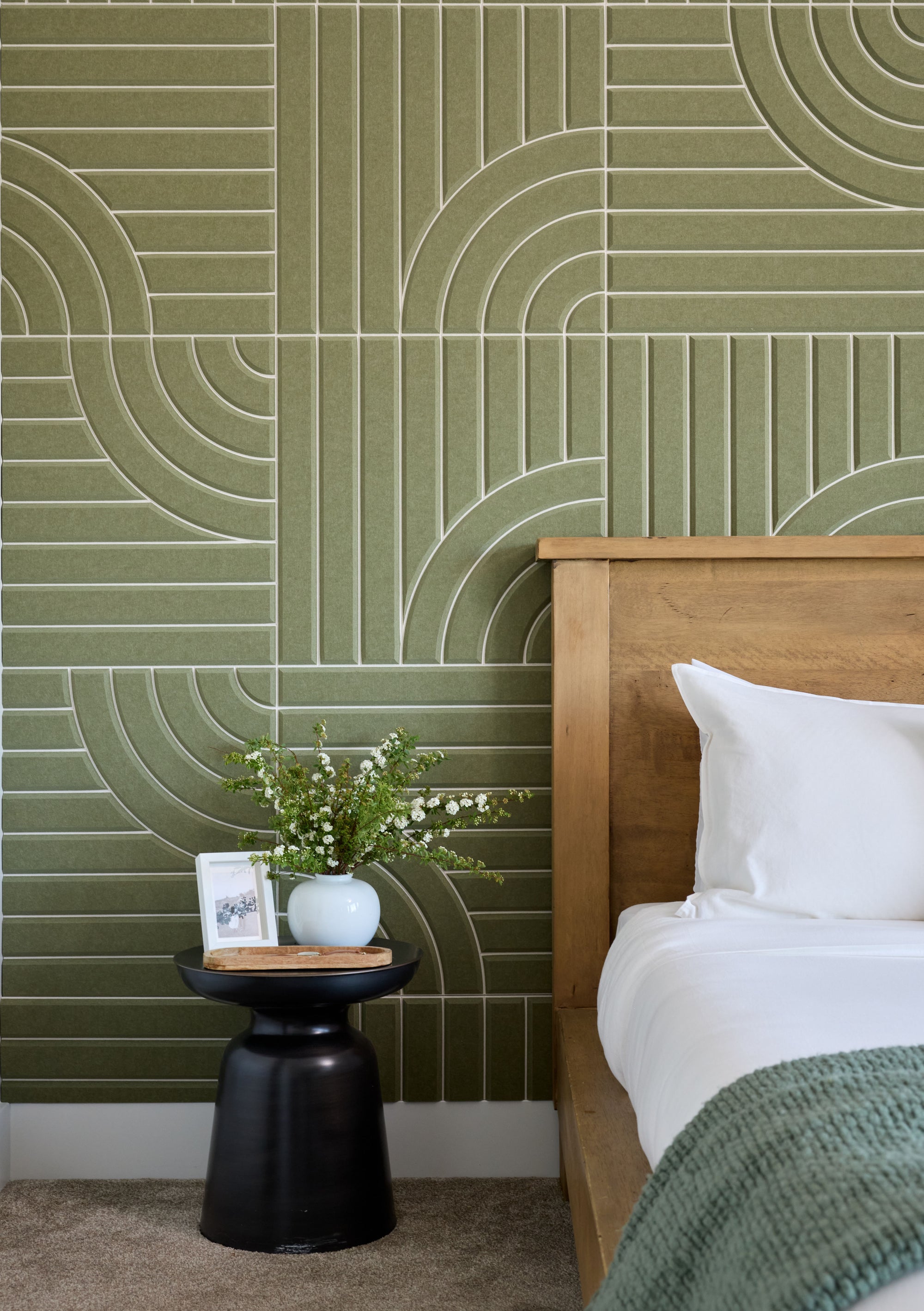 Cashmere colored Felt Right 2' x 2' tiles with white printed patterns in the shape of aspen tree trunks. There is a bed, two night stands, and two lamps in the foreground.