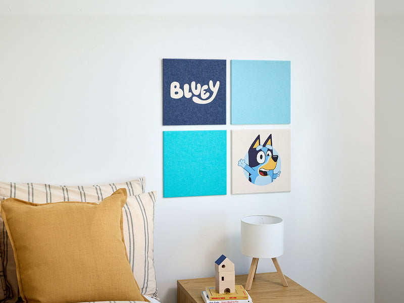 Four-panel wall art with 'Bluey' character and text in a living room setting.