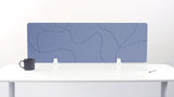 Blue desk divider with curved line pattern mounted on white desk with white supports.