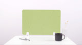 Green desk divider with curved topographic pattern displayed on white desk with support feet.