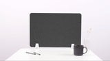 Dark gray desk divider with curved topographic pattern and white support feet on white surface.