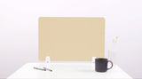 Beige desk divider with topographic line pattern, positioned upright on white desk surface with support legs.