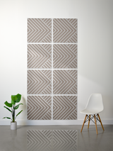 Eight square tiles with tan and white chevron engraved patterns arranged in a 2x4 grid on a wall.