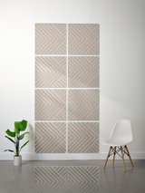 Eight square tiles with engraved chevron and diagonal line patterns in beige and white, arranged in a grid on a wall.