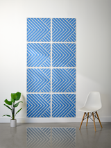 Eight blue square tiles with white diagonal stripe and chevron engraved pattern arranged in a grid layout.