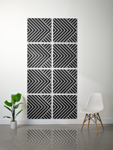 Eight black and white tiles with engraved diagonal and chevron patterns arranged in a 2x4 grid on a wall.