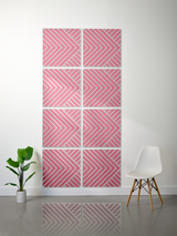 Eight pink and gray square tiles with engraved chevron and diagonal stripe patterns arranged in a grid formation on a wall.