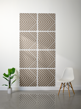 Eight taupe tiles with white engraved diagonal chevron pattern arranged in a 2x4 grid on a wall.