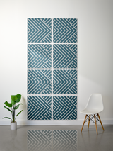Eight teal tiles with white engraved diagonal stripe and chevron patterns arranged in a 2x4 grid on a wall.