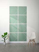 Eight green and white tiles with engraved chevron and diagonal line patterns arranged in a 2x4 grid on a wall.