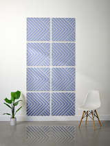 Eight blue tiles with white engraved chevron pattern arranged in a 2x4 grid on wall.