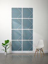 Eight teal and white tiles with chevron and diagonal stripe engraved pattern arranged in a grid.