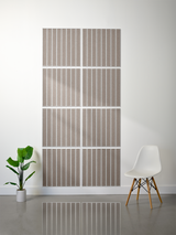 Eight gray tiles with vertical engraved parallel lines arranged in a 2x4 grid on a wall.