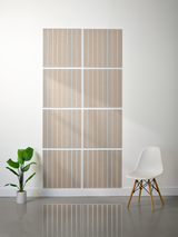 Eight beige tiles with parallel line engraving arranged in a 2x4 grid on white wall.