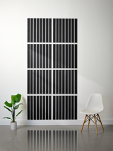Eight black tiles with vertical parallel line engravings arranged in a 2x4 grid on a white wall.