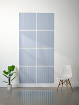 Eight light blue tiles with vertical parallel line engraving arranged in a 2x4 grid on a wall.
