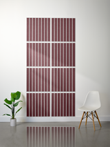 Eight burgundy tiles with vertical parallel line engravings arranged in a 2x4 grid on a white wall.