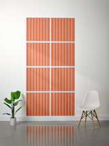 Eight square terracotta tiles with white parallel line engravings arranged in a grid pattern on a wall.