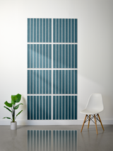 Eight teal tiles with white parallel line engravings arranged in a 2x4 grid on a white wall.