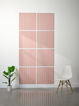 Eight terracotta tiles with vertical parallel line engravings arranged in a 4x2 grid on a wall.